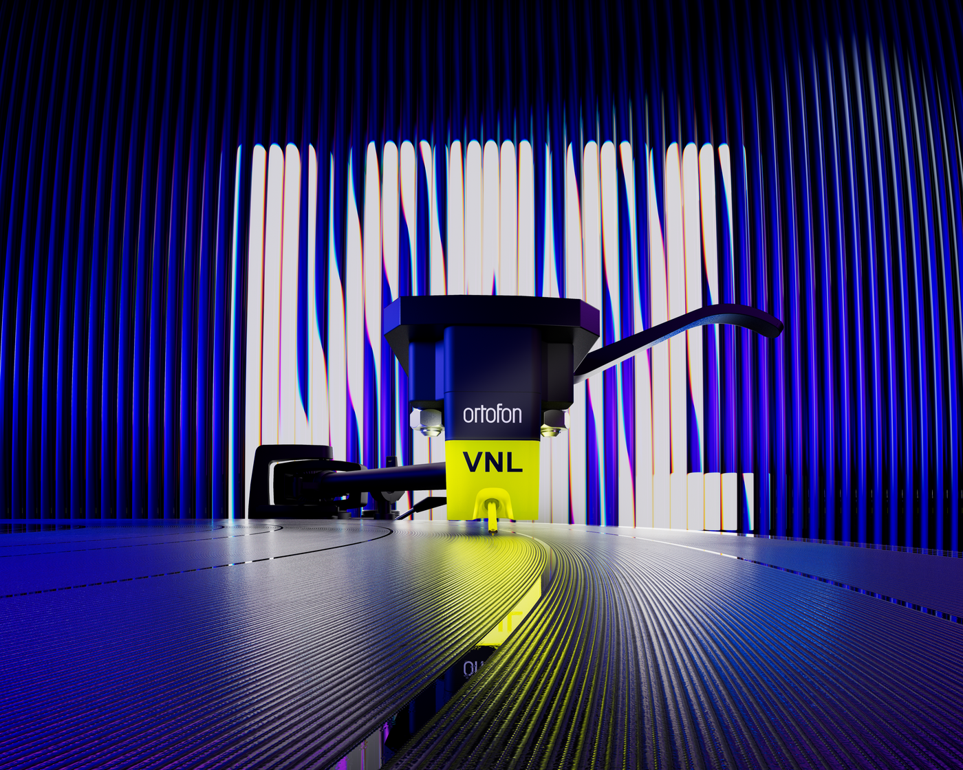 Ortofon VNL Dance cartridge on a dark surface with a colorful striped background