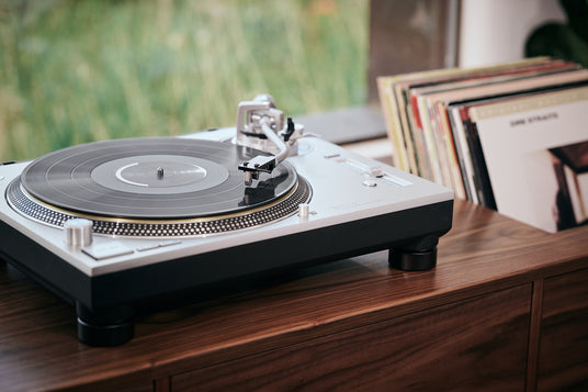 MC A Mono cartridge displayed on a turntable with vinyl records in the background